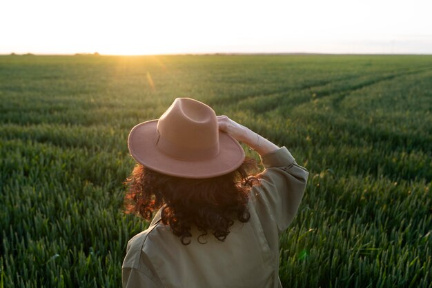 Medium shot woman with hat in nature