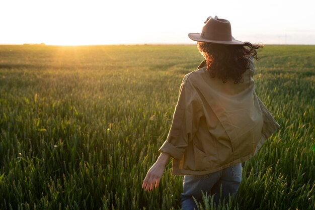 Medium shot woman with hat outside