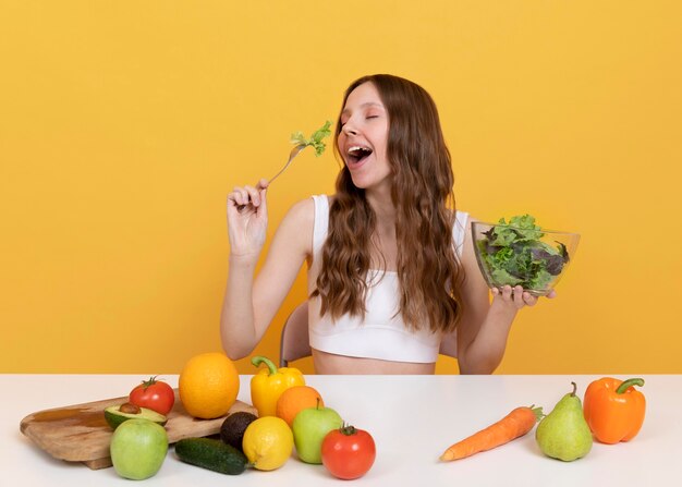 Medium shot woman with healthy vegetables