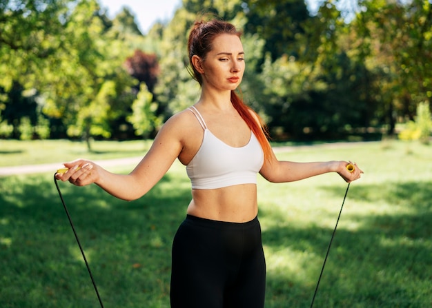 Medium shot woman with jumping rope