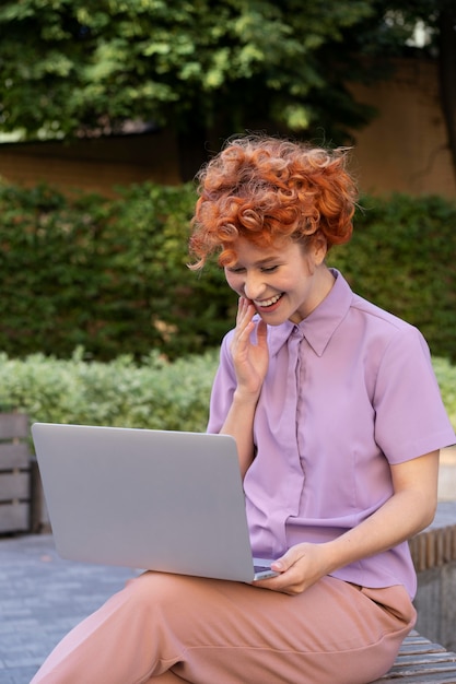 Medium shot woman with laptop