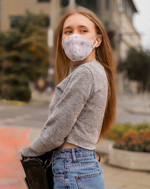 Medium shot woman with medical mask