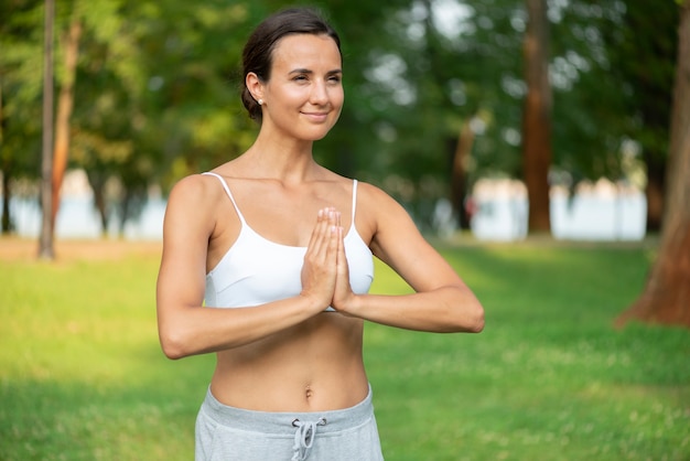 Medium shot woman with meditating arm pose