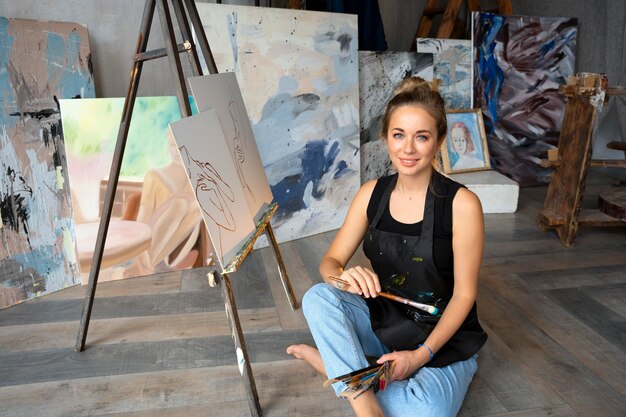 medium shot woman with painting brushes