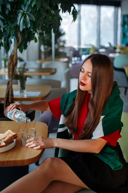 Free photo medium shot woman with paper-wrapped sandwich