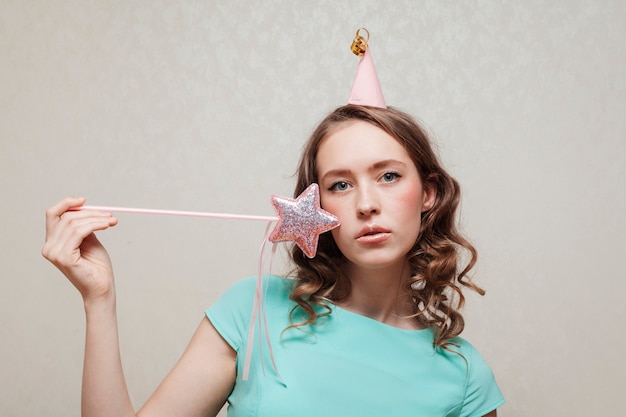 Medium shot of woman with party hat and star