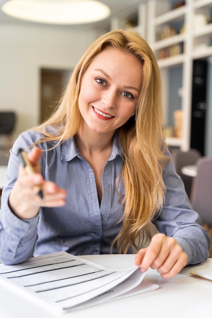 Medium shot woman with pen