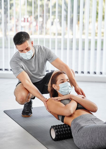 Medium shot woman with personal trainer