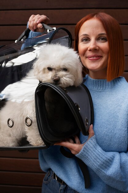 Medium shot woman with pet carrier