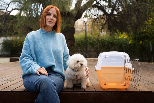 Medium shot woman with pet carrier