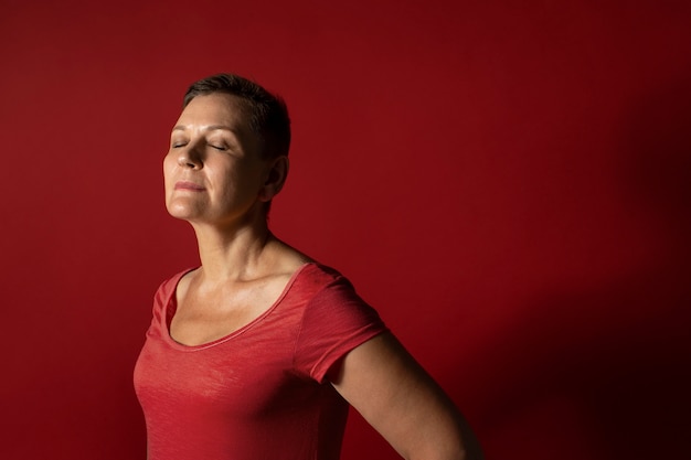 Medium shot woman with red background