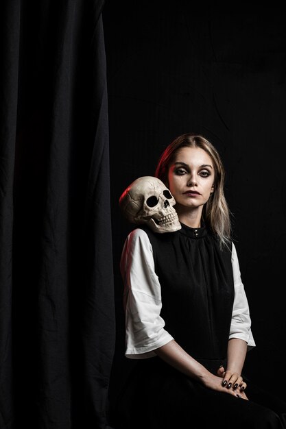 Medium shot of woman with skull on shoulder