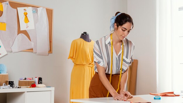 Medium shot woman with tailoring meter