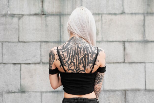 Medium shot woman with tattoos on back