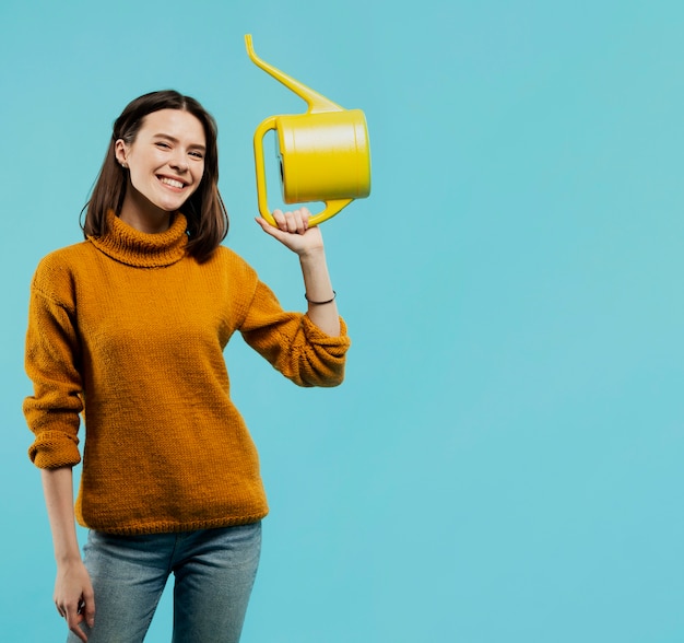 Medium shot of woman with watering can