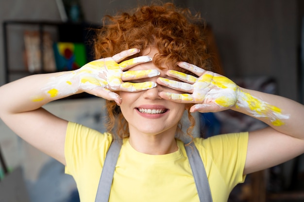 medium shot woman with yellow paint