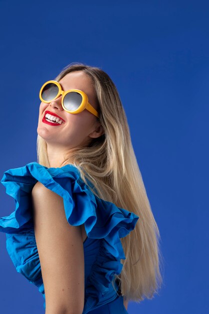 Medium shot woman with yellow sunglasses