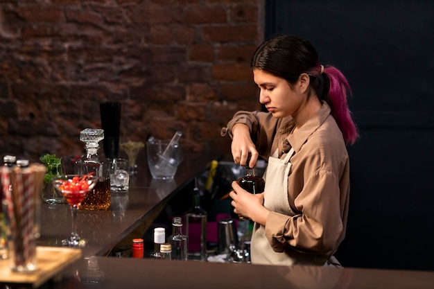 Free photo medium shot woman working as bartender