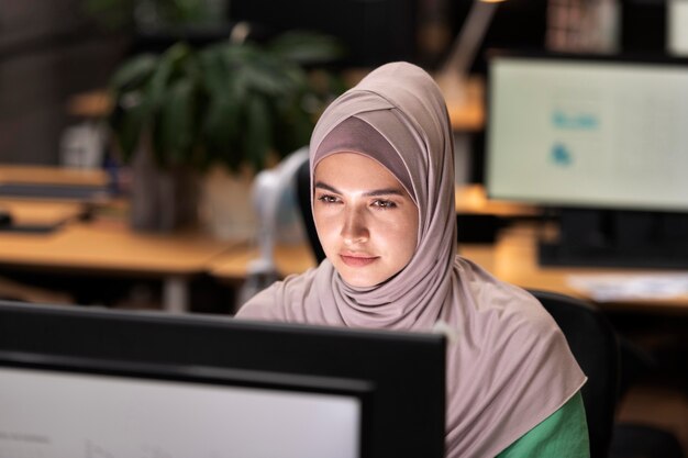 Medium shot woman working on computer