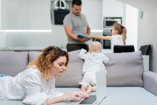 Medium shot woman working on couch