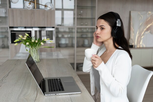 Medium shot woman working from home