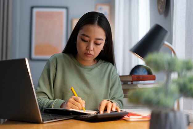 Medium shot woman working from home