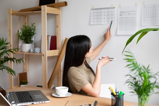 Medium shot woman working at home