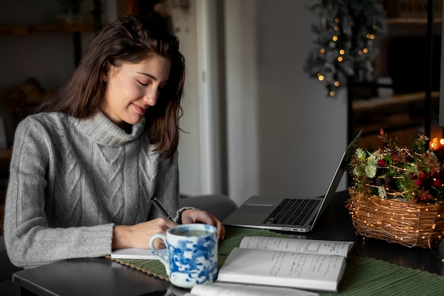 Medium shot woman working at home