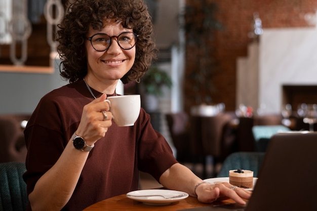 Medium shot woman working on laptop