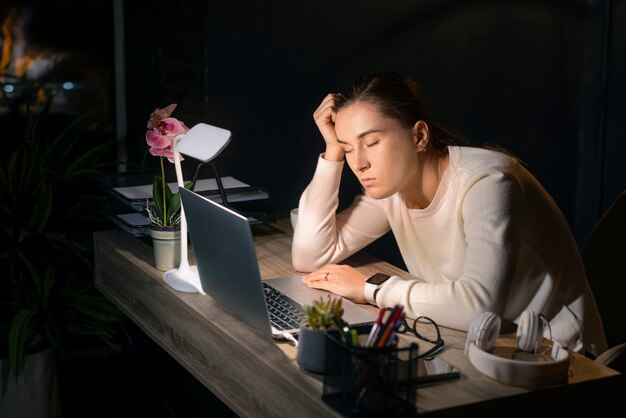 medium shot woman working late at night