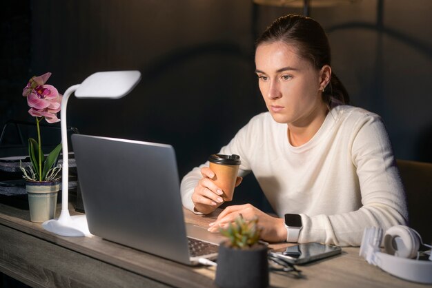 medium shot woman working late at night