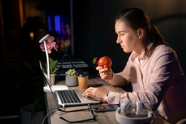 medium shot woman working late at night