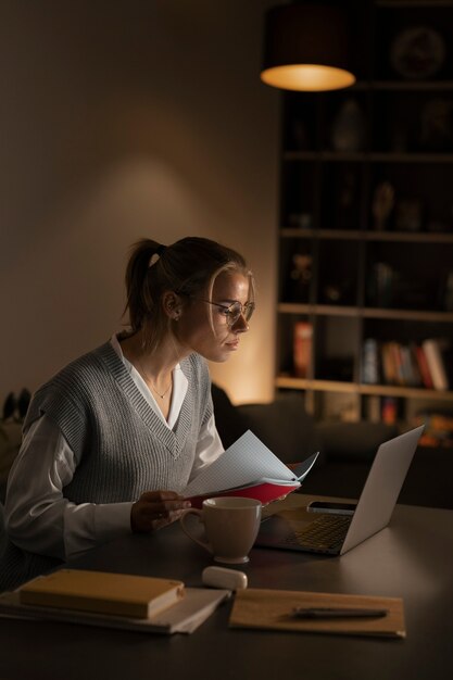 Medium shot woman working late at night