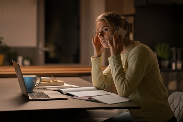 Medium shot woman working late at night