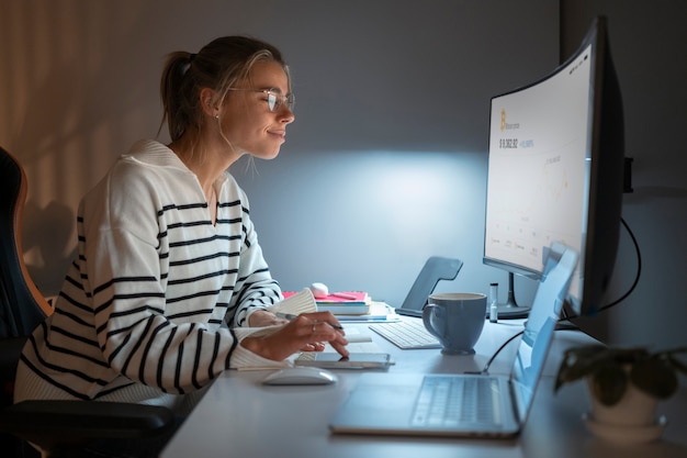 Medium shot woman working late at night