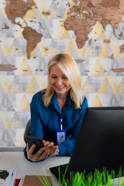 Medium shot woman working in the office of a travel agency