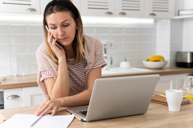 Medium shot woman working remotely