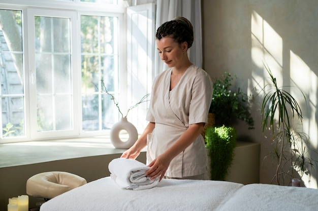 Medium shot woman working at a spa