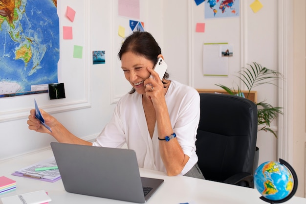 Medium shot woman working in  travel agency