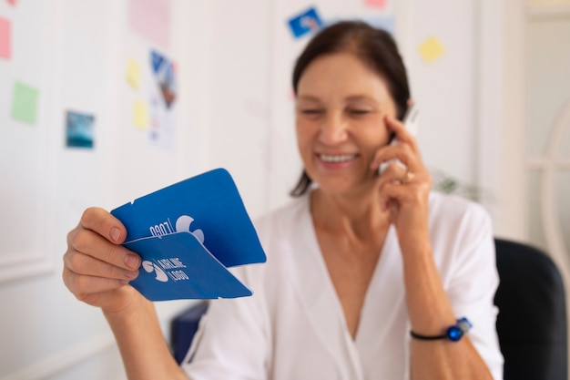 Free photo medium shot woman working in  travel agency