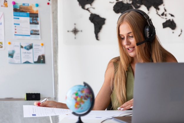 Free photo medium shot woman working in travel agency