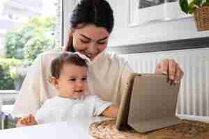 Free photo medium shot woman working with baby