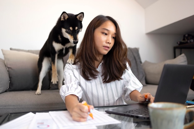 Medium shot woman working with laptop