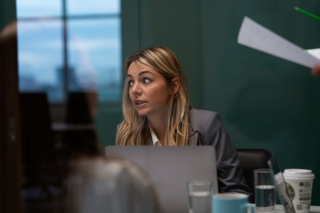 Medium shot woman working with laptop