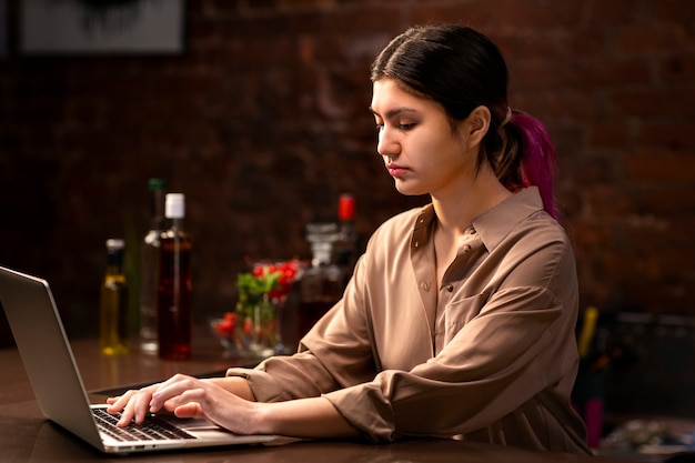 medium shot woman working with laptop