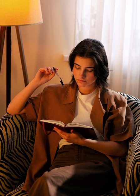 Free photo medium shot woman writing in her journal