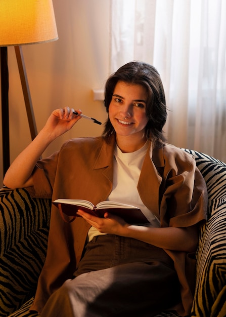 Free photo medium shot woman writing in her journal