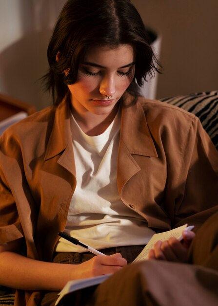 Medium shot woman writing in her journal