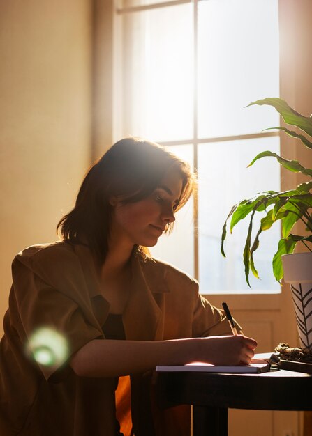 日記を書いているミディアムショットの女性