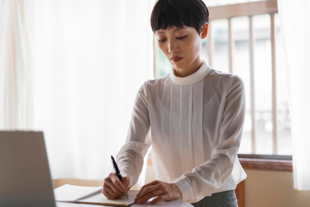 Free photo medium shot woman writing message